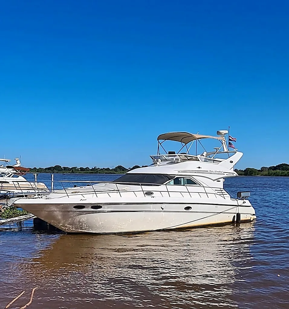 The 44-foot yacht moored on the Paraguay River, flying the Paraguayan flag